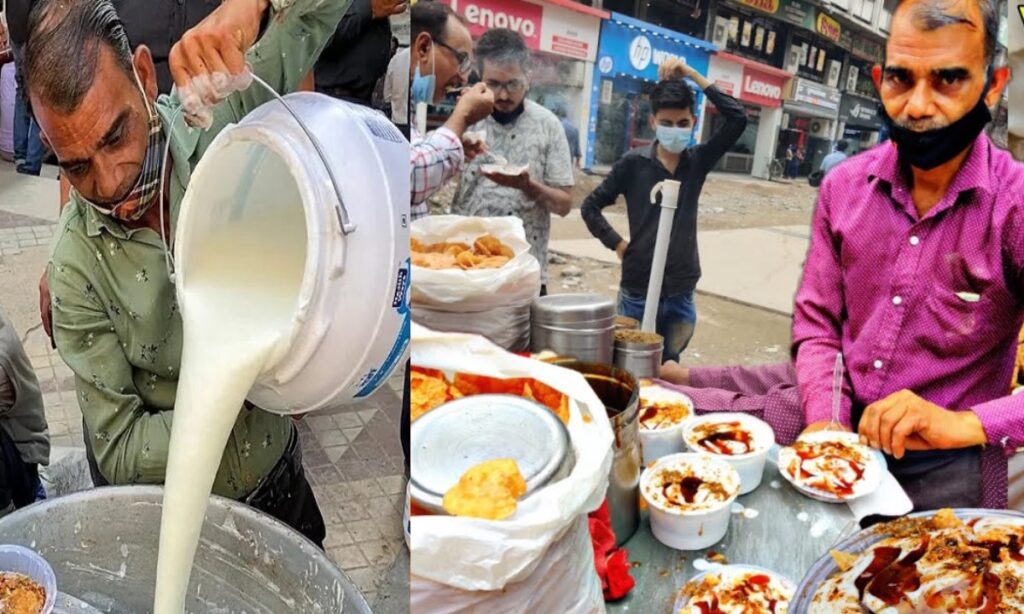 Delhi Crorepati Bhallewala: दिल्ली की सड़कों पर ₹2 के भल्ले बेचने वाले मुकेश शर्मा आज एक करोड़ों के ब्रांड के मालिक हैं, उनकी कहानी सिर्फ भल्लों की नहीं, बल्कि जुनून, मेहनत और आत्मविश्वास की मिसाल है, मुकेश शर्मा की सफलता का सफर दिखाता है कि अगर इंसान ठान ले, तो कोई भी मंज़िल दूर नहीं। हम अक्सर सोचते हैं कि करोड़पति बनने के लिए बड़ा व्यापार या ऊँची डिग्री चाहिए लेकिन दिल्ली के एक साधारण भल्लेवाले ने इस सोच को गलत साबित कर दिया और आज दिल्ली की तंग गलियों में एक ऐसा नाम बन गए है जिसे लोग सिर्फ उसके स्वाद नहीं, बल्कि संघर्ष और सफलता के लिए भी जानते हैं, भल्लेवाले अंकल जिन्होंने ₹2 में भल्ले बेचकर अपना सफर शुरू किया और आज BMW में घूमते हैं।